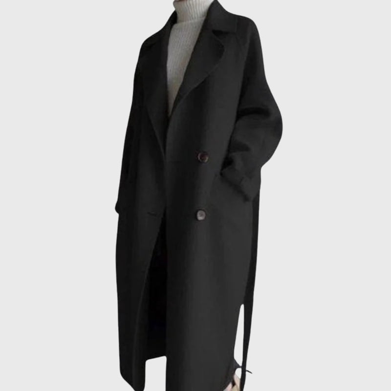 Model styled in a brown longline overcoat layered over a dress for an elevated look