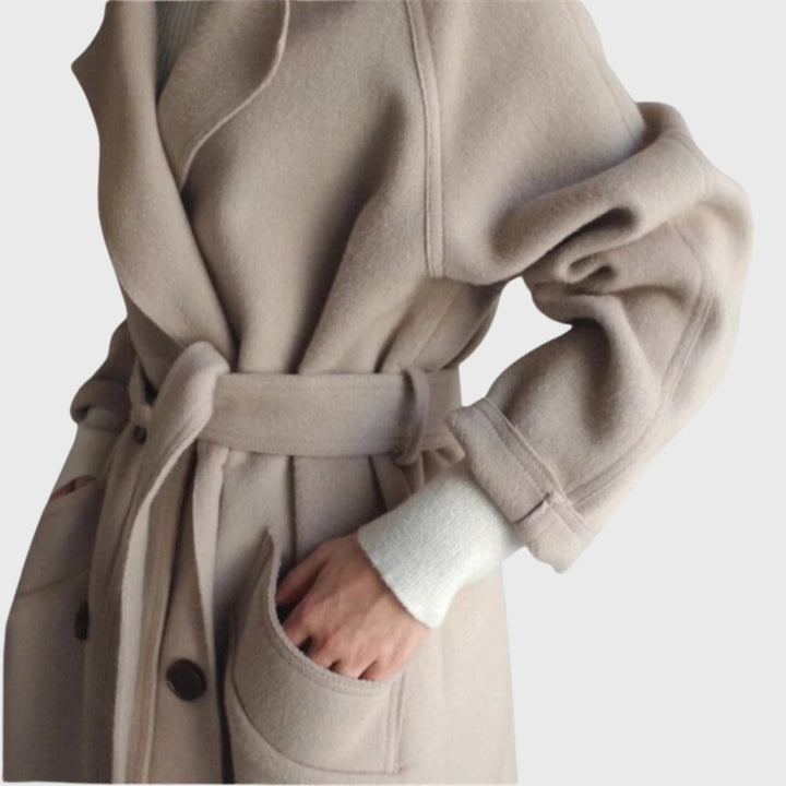 Back view of a black longline overcoat showing the elongated cut and structured fit