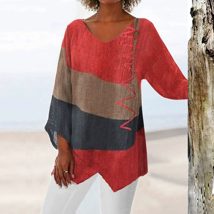 Woman wearing a red brushstroke print long shirt with V-neck and asymmetrical hem