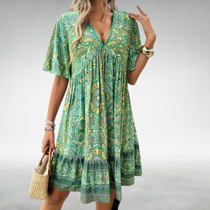 Front view of the Dahlia women's cocktail dress highlighting the smooth, flowing fabric and refined design accents