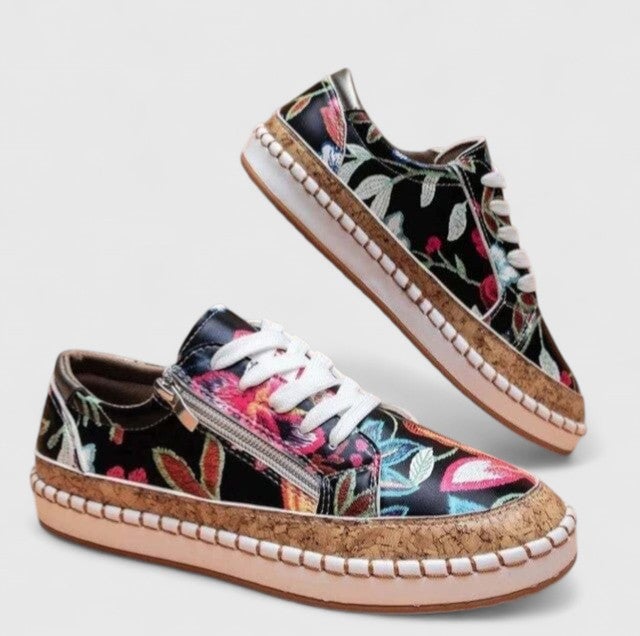 Close-up of Dahlia sneaker upper highlighting multicolor floral embroidered print and gold metallic toe cap accent