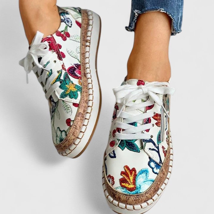 Rear view of Dahlia floral platform sneaker showing gold metallic heel accent and side zipper closure