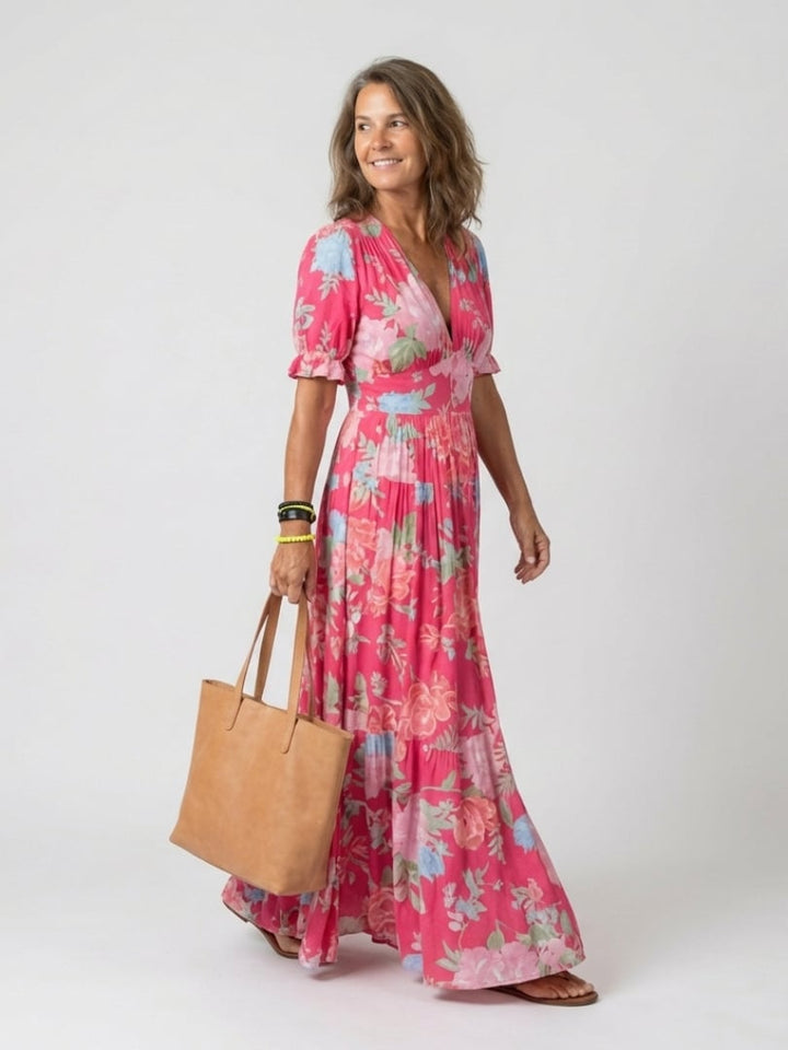 Front view of the Dahlia floral midi dress in sky blue showing the V-neckline and tiered skirt