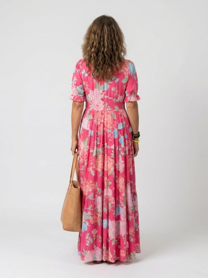 Side view of the Dahlia floral midi dress in green highlighting the flowing tiered silhouette