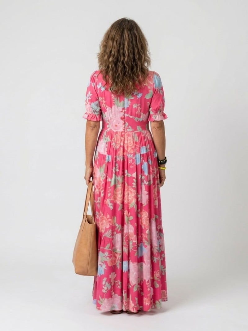 Side view of the Dahlia floral midi dress in green highlighting the flowing tiered silhouette