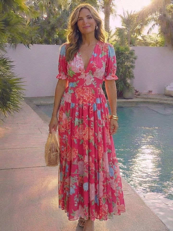 Model styled in the Dahlia floral midi dress in pink with sandals for a garden party look