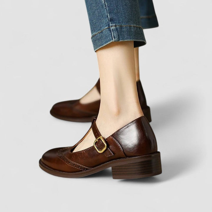 Close-up of the Mary Jane strap buckle detail on the Daisy shoes in brown