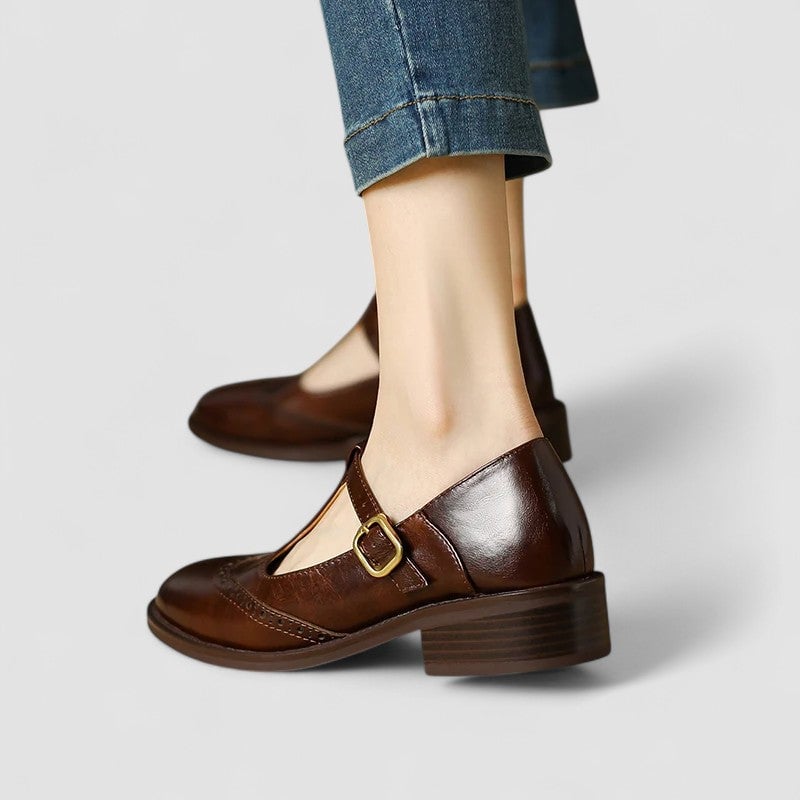 Close-up of the Mary Jane strap buckle detail on the Daisy shoes in brown