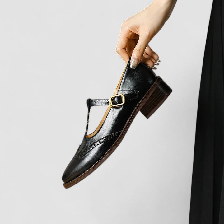 Daisy Mary Jane shoes in black shown from a three-quarter angle on a clean white background