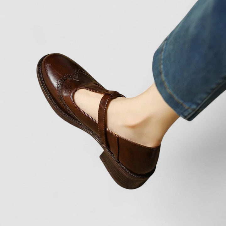 Lifestyle flat lay of the Daisy Mary Jane shoes in brown alongside casual wardrobe pieces