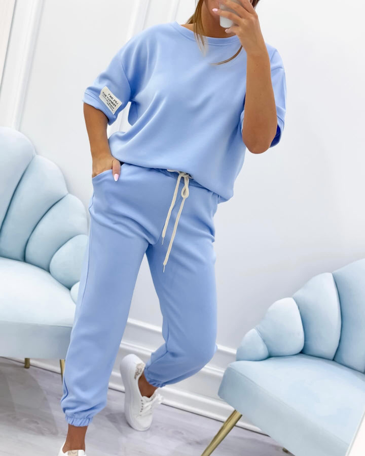 Blue short sleeve two-piece set with breathable fabric detail on a model