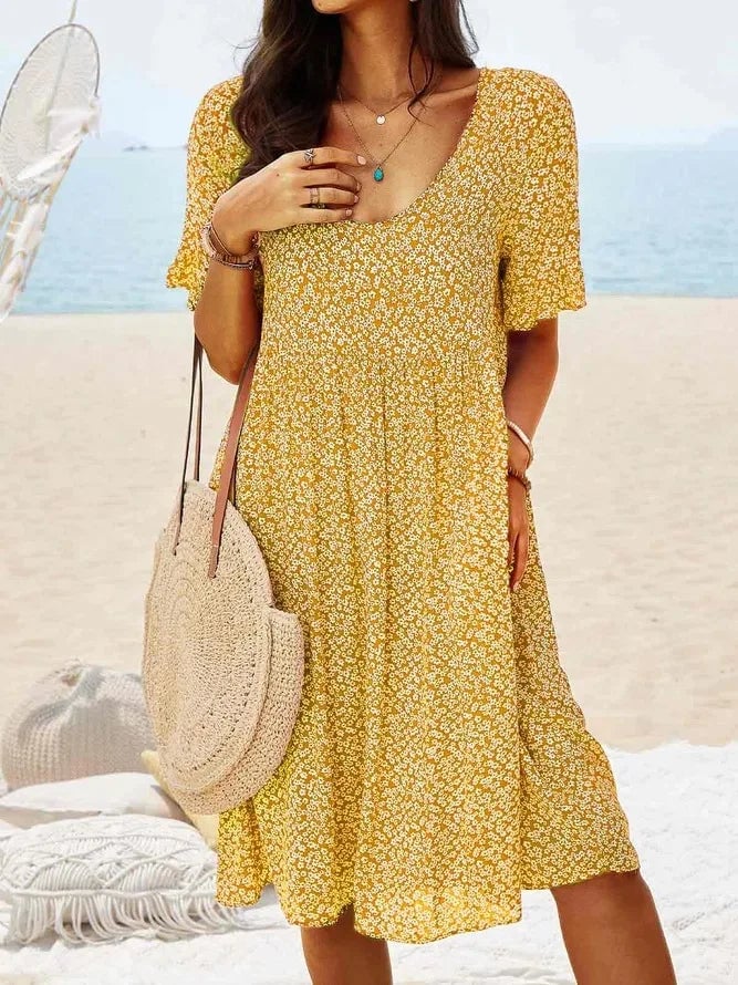 Side view of the floral smock dress highlighting the tiered skirt silhouette and flutter sleeves