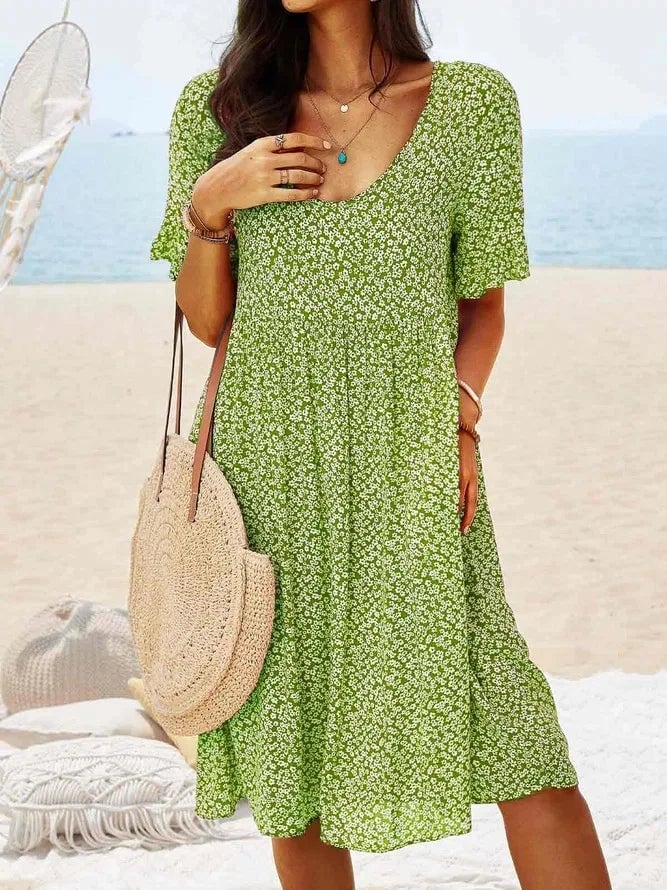 Close-up of the smocked bodice and ditsy floral print on the women's summer dress
