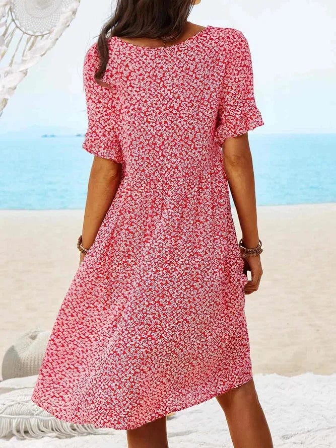 Flat lay of the ditsy floral smock dress showing the full length and side pocket detail