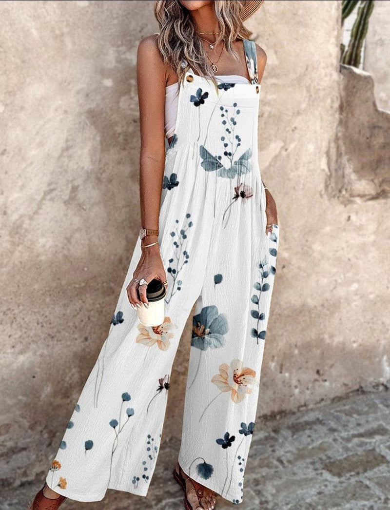 Side view of the white Daisy overalls jumpsuit highlighting the flowing wide-leg trousers and side pocket detail