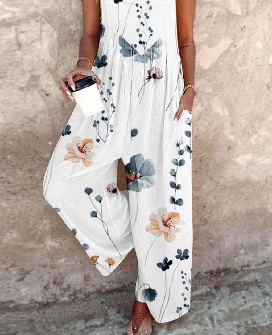 Full-length back view of the black Daisy floral wide-leg overalls jumpsuit on a female model