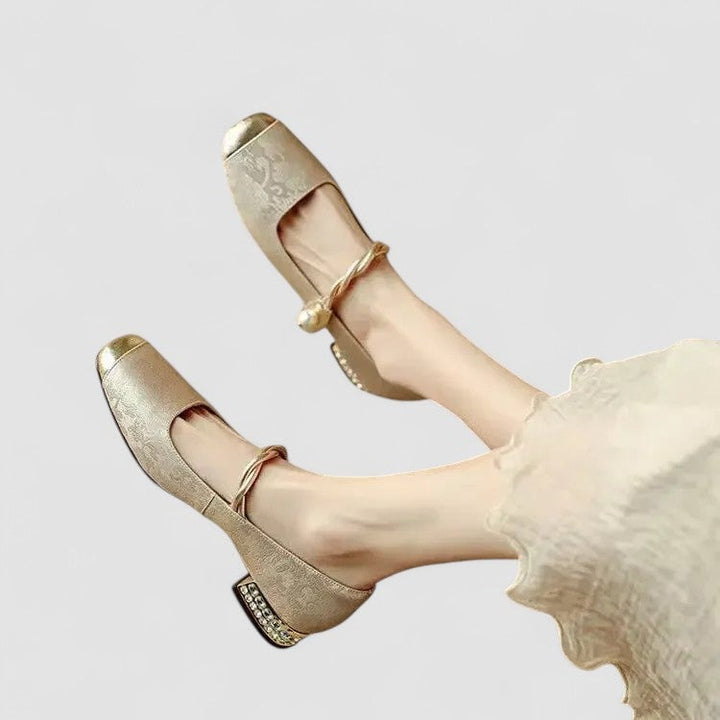 Woman wearing beige orthopedic mary jane shoes styled with a floral skirt