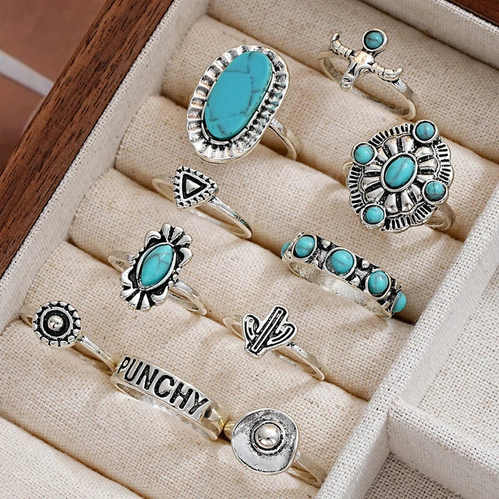 Model wearing multiple turquoise stacking rings across both hands