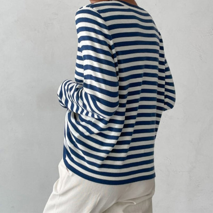 Model wearing the Dana striped T-shirt in purple, styled with a tote bag for an effortless daytime outfit