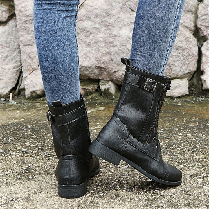 Orthopedic boots in gray styled with straight-leg jeans on a light background