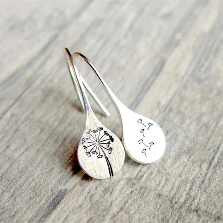 Sterling silver dandelion earrings styled on a model showing scale and drape