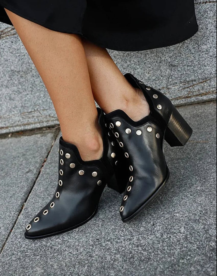Black studded wide-heel boots with metallic stud detailing and smooth finish, front view