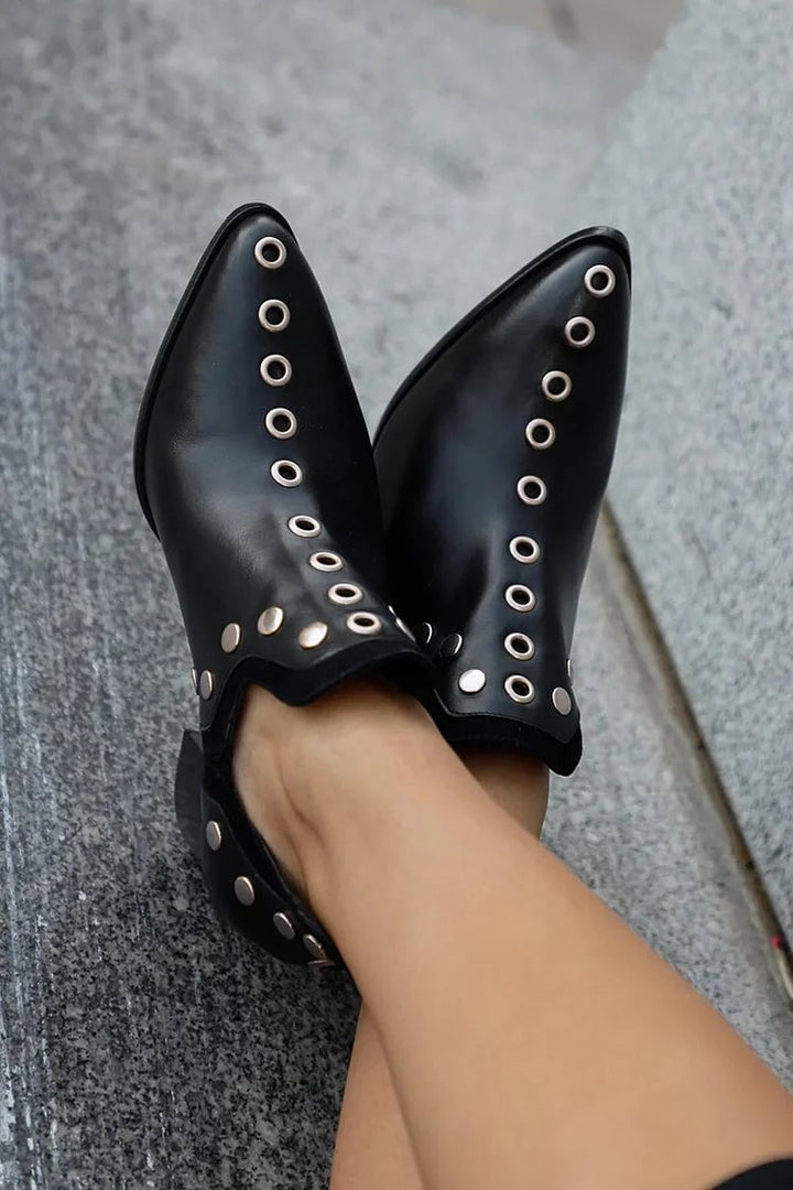 Black studded wide-heel boots side profile highlighting stable block heel and sleek silhouette