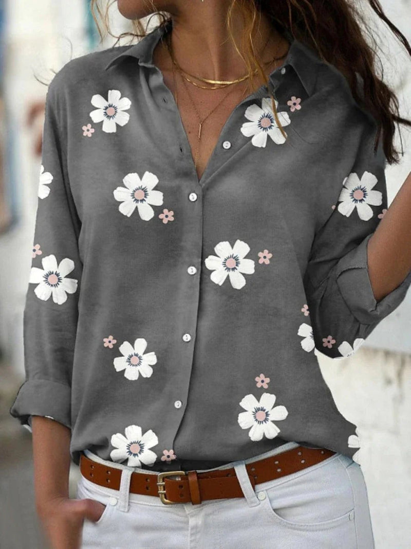 Close-up of floral print blouse showing delicate pattern detail and button-down front closure
