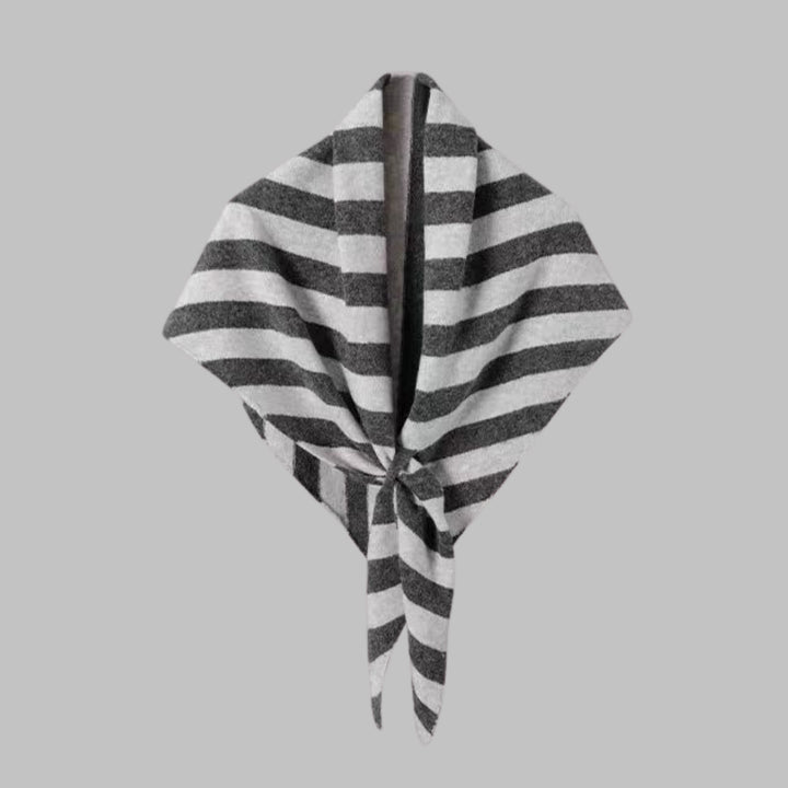 Navy striped triangle shawl worn loosely around the neck