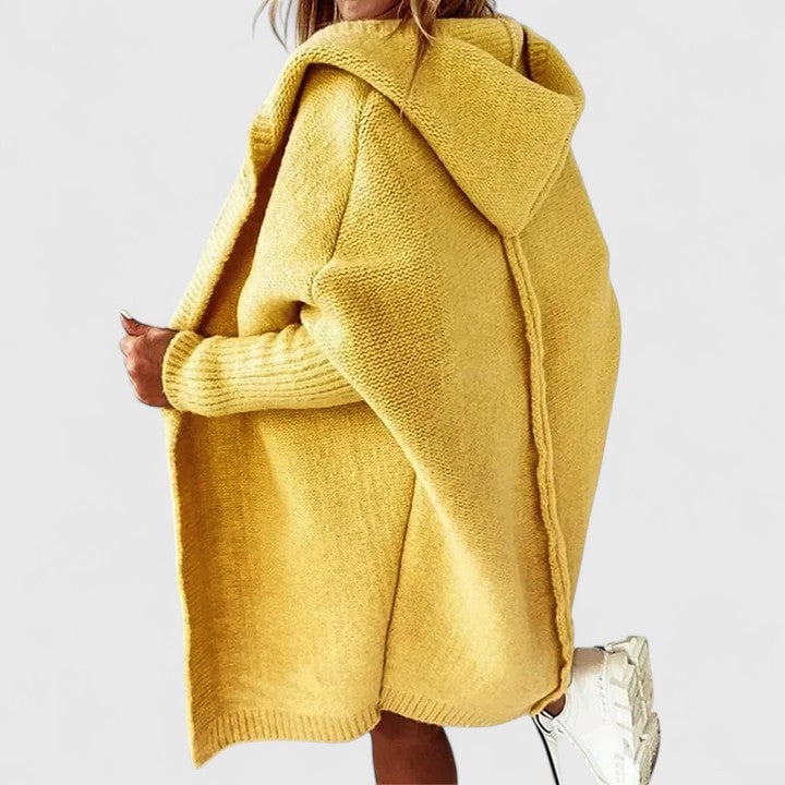 Full-length shot of a yellow knee-length hooded knit cardigan with relaxed fit