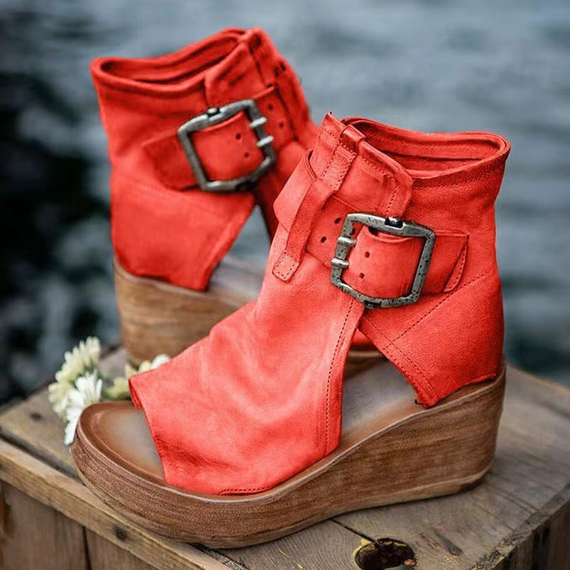 Red boho wedge sandals with buckle closure, side view on white background