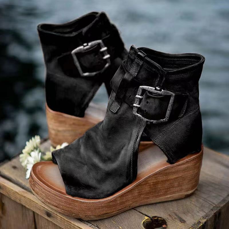 Black boho wedge sandals with buckle closure, side view on white background