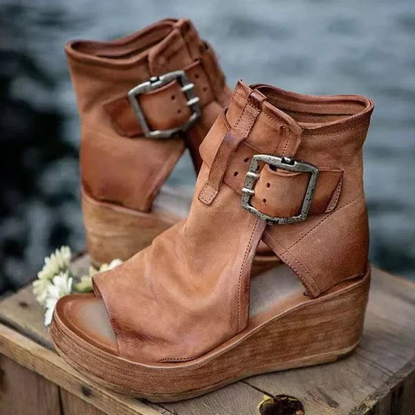 Brown boho wedge sandals with buckle closure, side view on white background