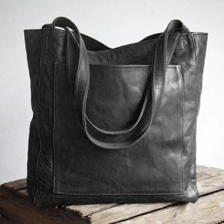 Debbie bag in dark brown displayed against a neutral background highlighting its structured shape