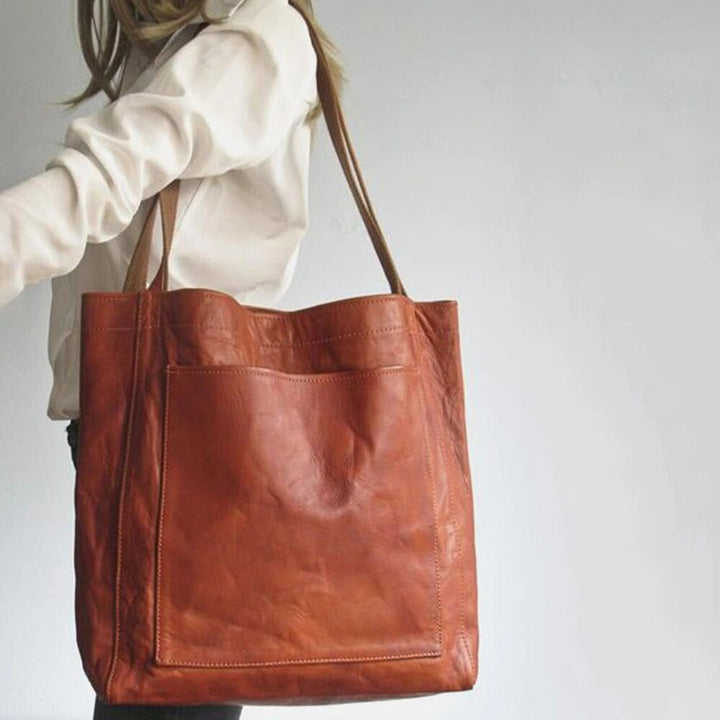 Model carrying the Debbie shoulder bag in black over her shoulder with a casual outfit