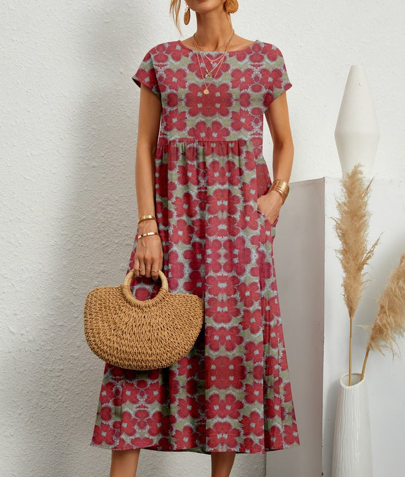 Close-up of elegant floral dress fabric showing detailed print, flared hem, and side pocket on a female model