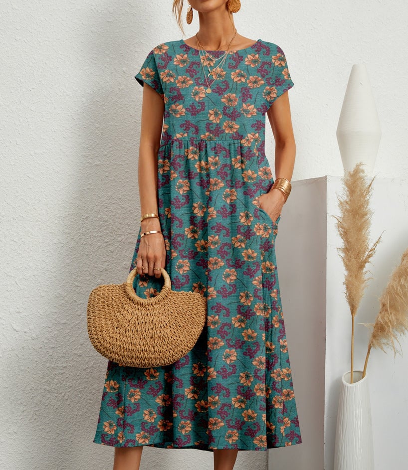 Model wearing the elegant floral dress outdoors in warm sunlight, showcasing the flattering silhouette and floral pattern