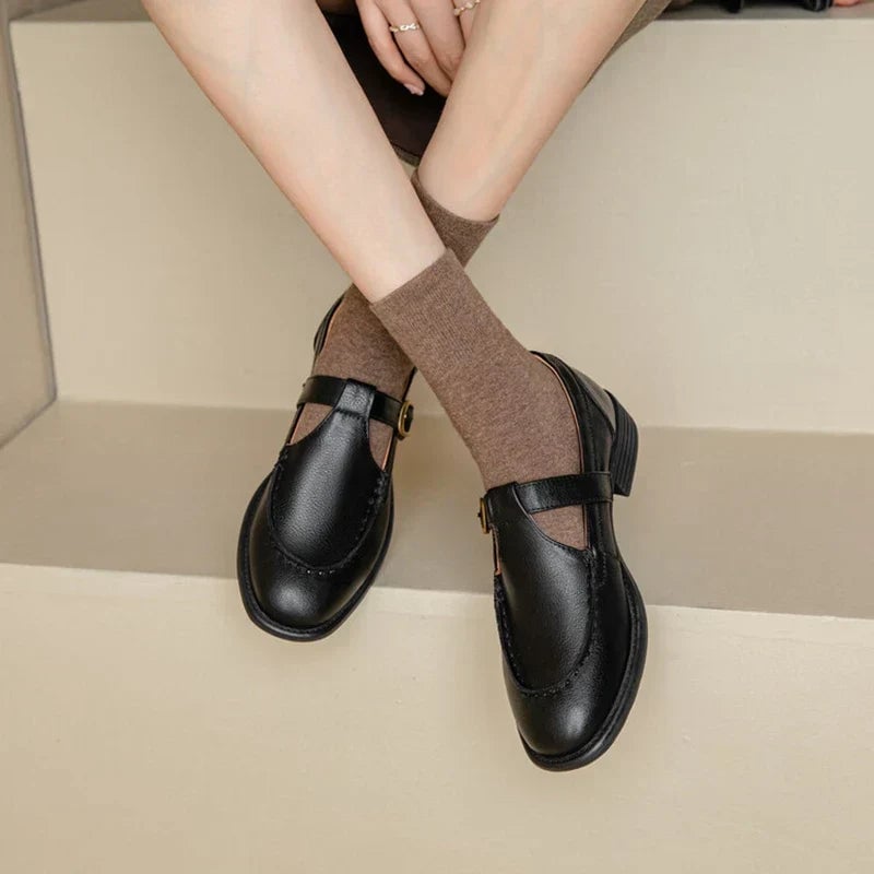 Delia retro T-strap Mary Jane shoes in black with gold-tone buckle and low block heel, front view