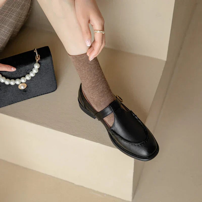 Delia retro Mary Jane shoes in black showing round toe and stitched detailing, side profile