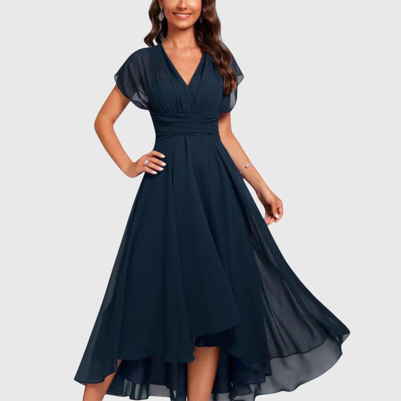 Woman wearing a blue v-neck wrap midi dress with short sleeves and a cinched waist, shown in full length