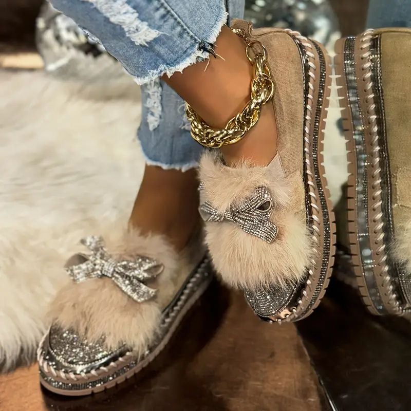 Close-up of sparkling crystal bow embellishment on women's slip-on loafers