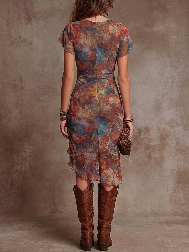 Side view of a flowing red abstract midi dress showing the midi hemline