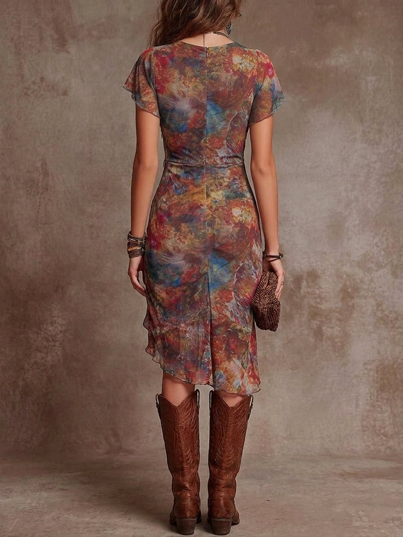 Side view of a flowing red abstract midi dress showing the midi hemline