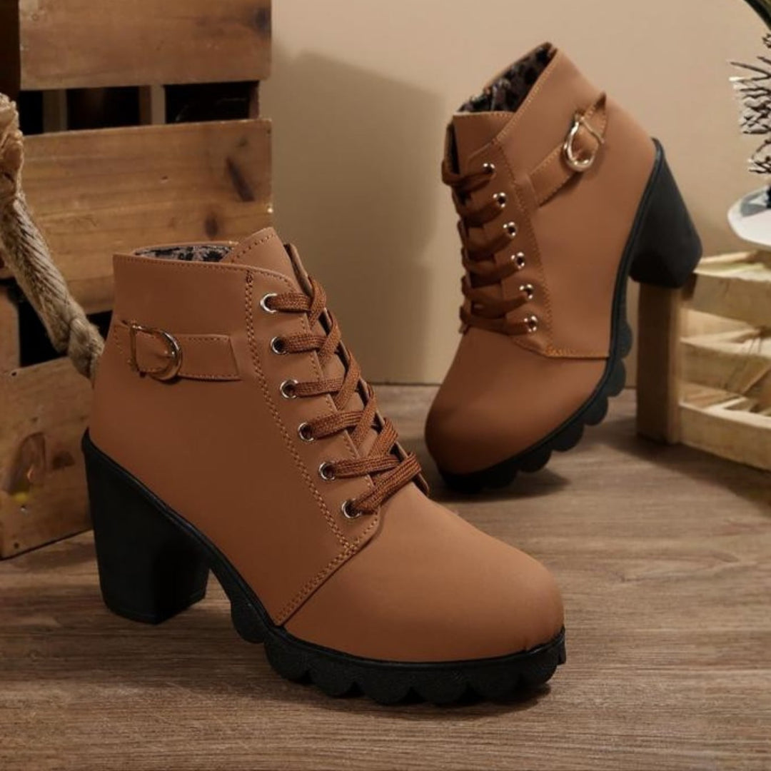 Side view of chunky ankle boots showing structured silhouette and lace-up detail
