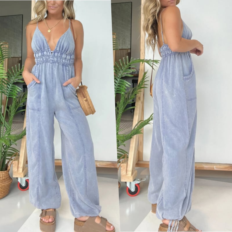 Side profile of the Demi denim jumpsuit in black highlighting the relaxed wide-leg fit