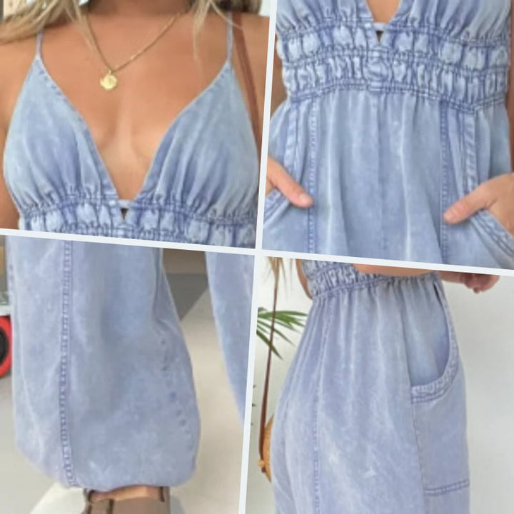 Side view of the Demi denim jumpsuit in dark blue showing wide-leg drape and overall silhouette
