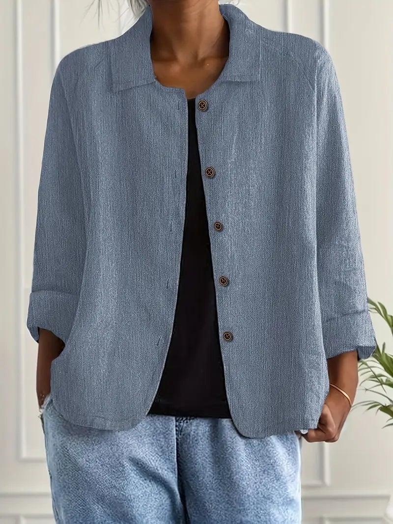 Model layering the lightweight top in blue under a jacket for a casual chic look