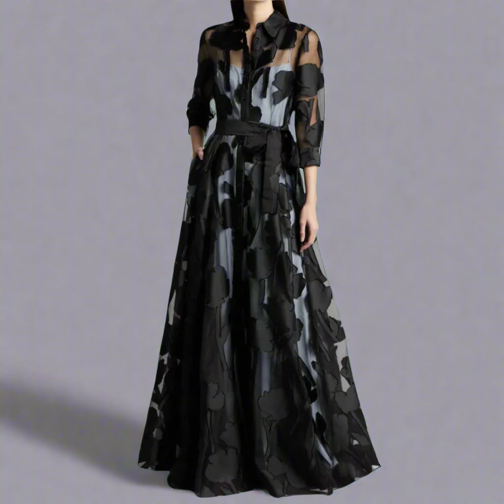 Woman wearing a long lightweight black maxi dress with a fluid silhouette and elegant drape