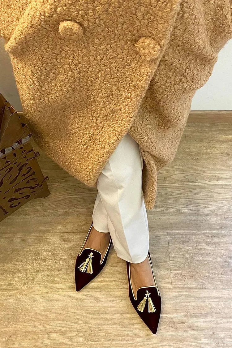 Denise tassel loafers in orange displayed at an angle to show the sleek upper and clean toe shape
