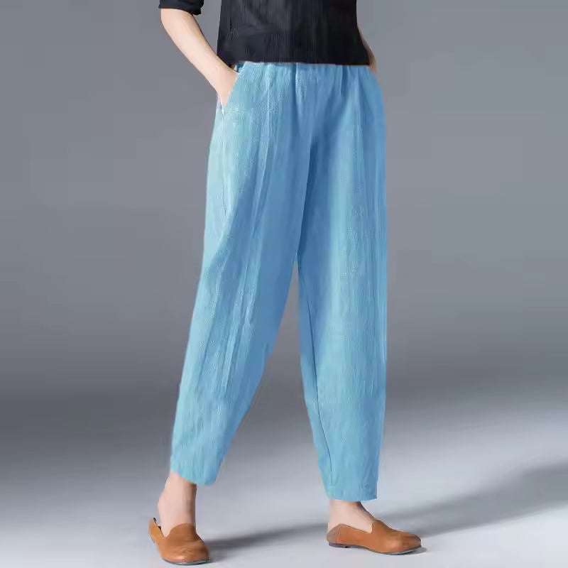Close-up of lightweight summer trousers in coffee brown showing relaxed drape and tapered ankle detail